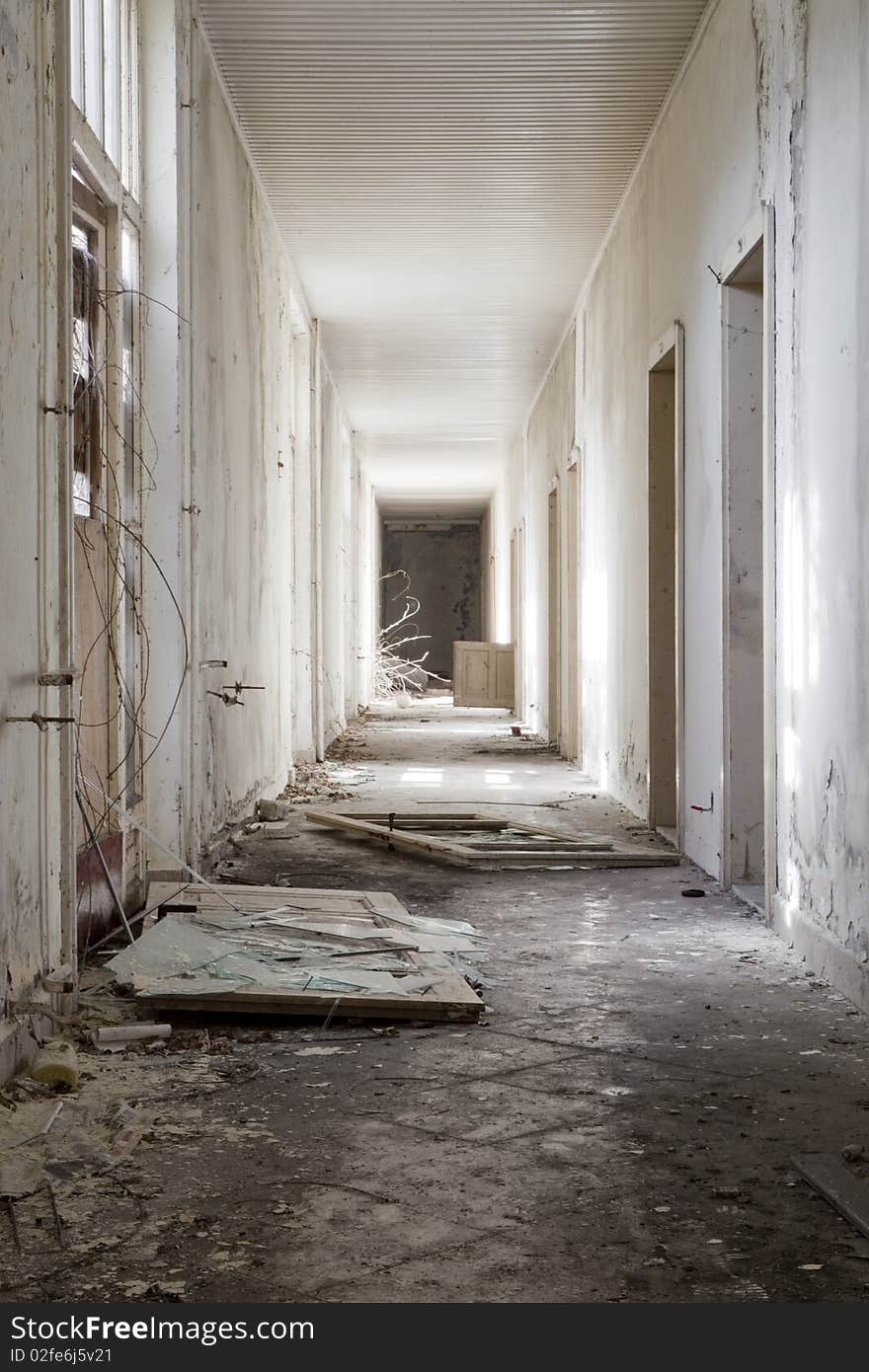 A long white corridor with broken glass. A long white corridor with broken glass