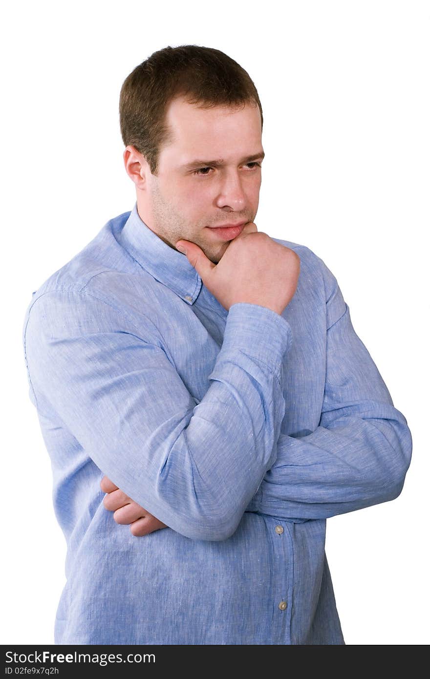 The man in a blue shirt thoughtfully rubs a chin, is isolated on a white background