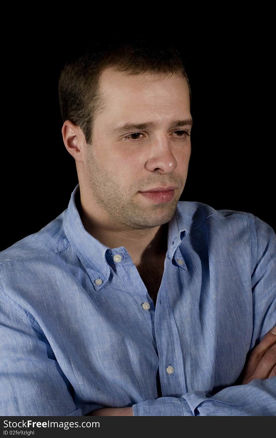 The man in a blue shirt on a black background