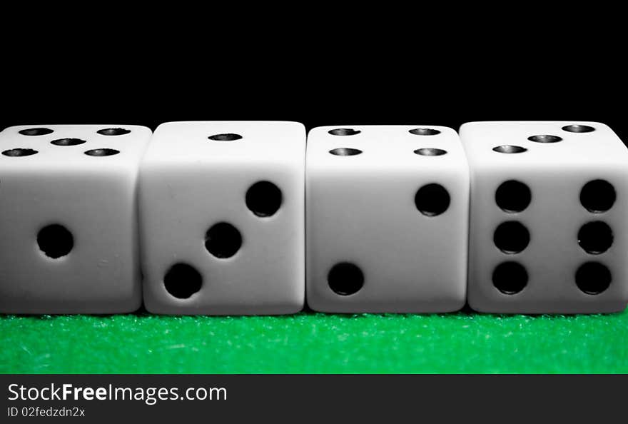 Dice lined up in a row on a felt table. Dice lined up in a row on a felt table