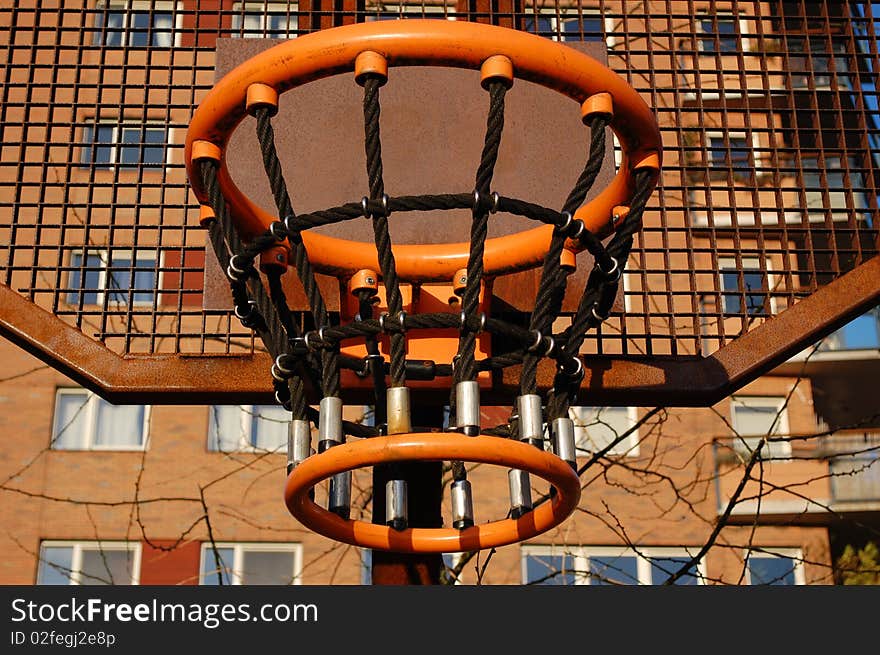 A basket on a sportsfield in the city. A basket on a sportsfield in the city