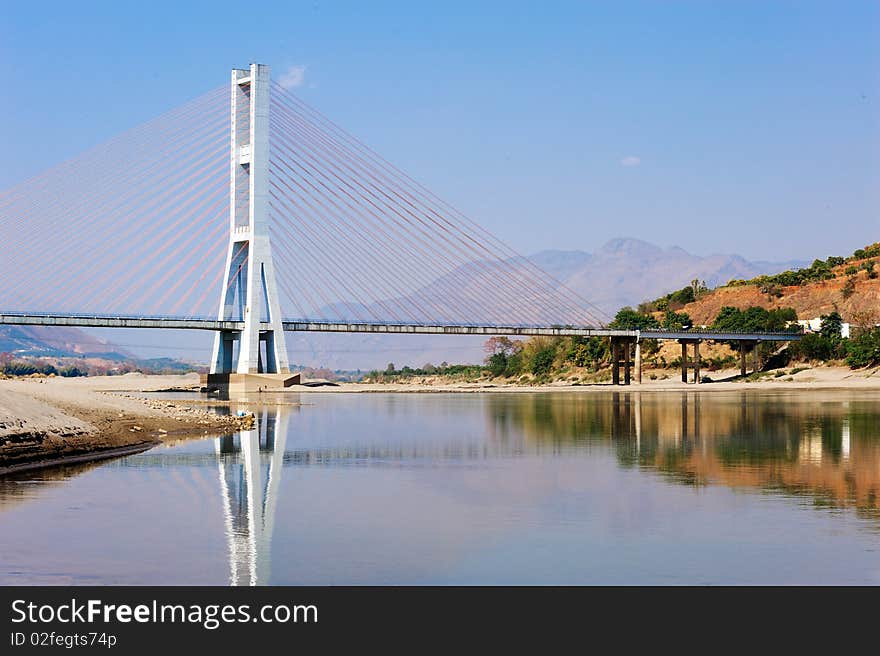 Cable bridge and blue sky on water. Cable bridge and blue sky on water.