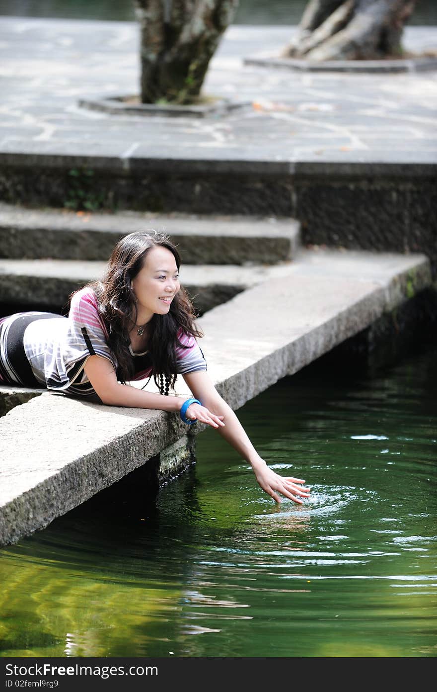 Chinese girl playing by water. Chinese girl playing by water.