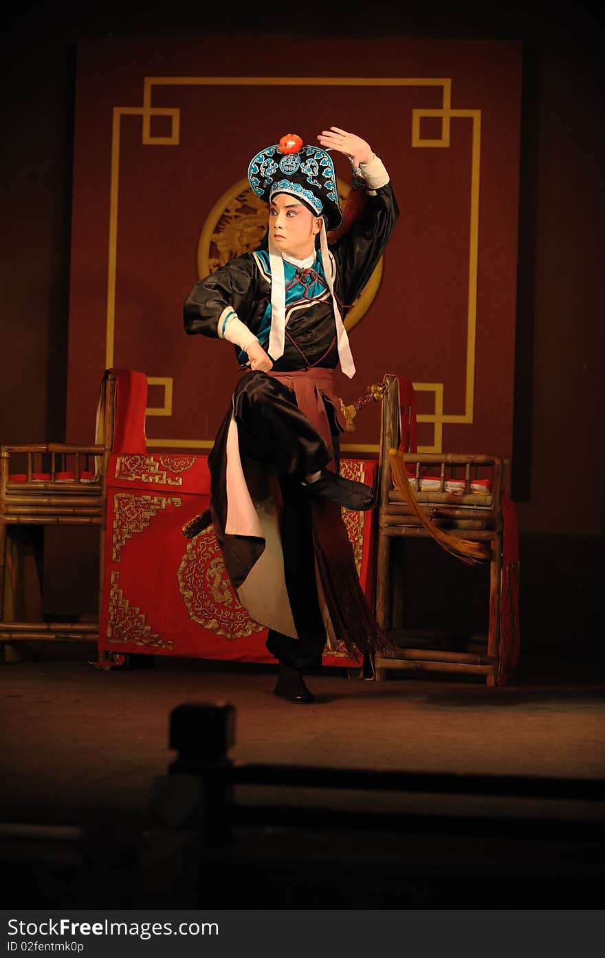 China opera actor with hat and sword.