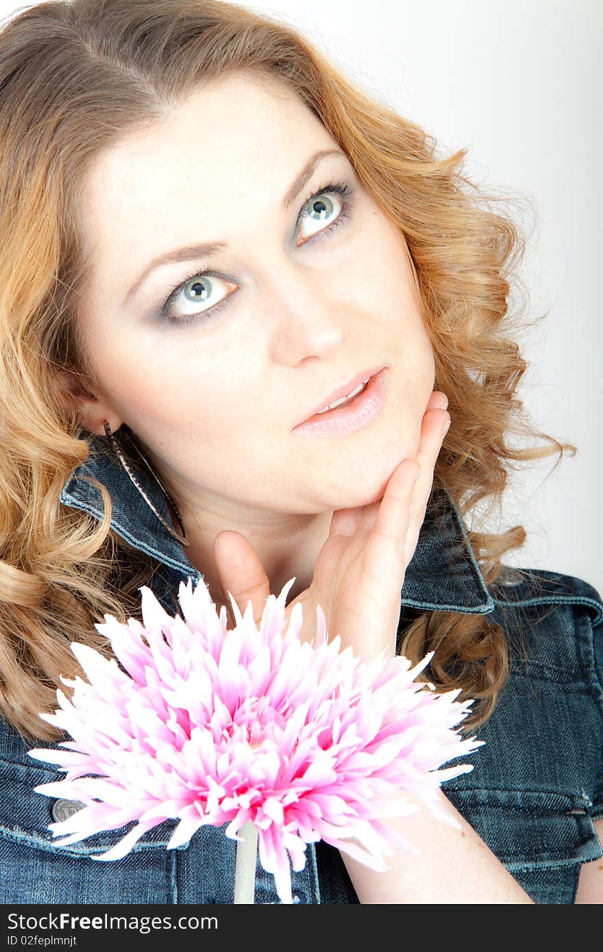 A young nice woman holding a flower. A young nice woman holding a flower