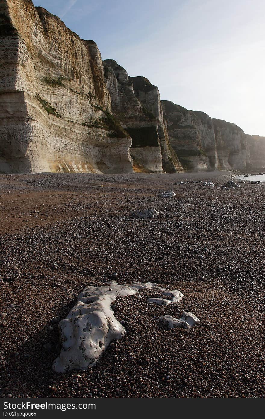 Normandy's beach whit high cliff and pebble on the floor. Normandy's beach whit high cliff and pebble on the floor