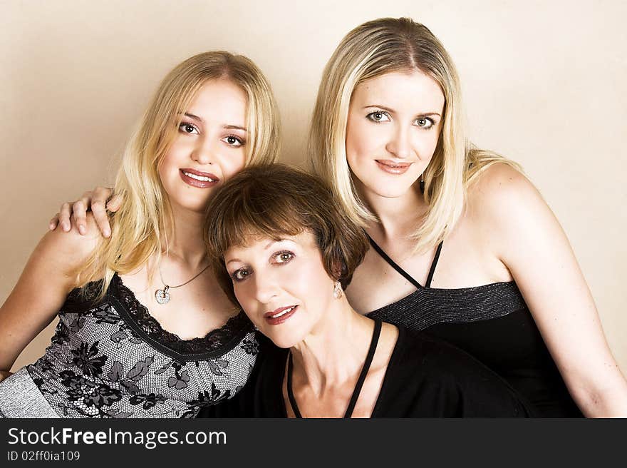 Beautiful blond daughters with their brunette mother. Beautiful blond daughters with their brunette mother