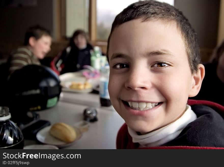 Smiling Boy Eating Lunch After Skiing. Smiling Boy Eating Lunch After Skiing