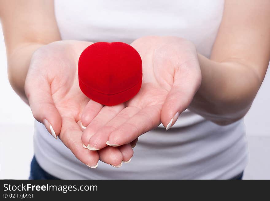 Close up photo of a red velvet box in a female hands