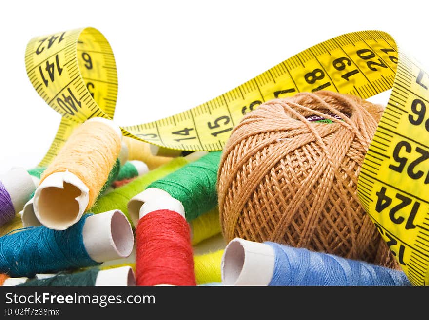 Colorful thread with measuring tape isolated in white background