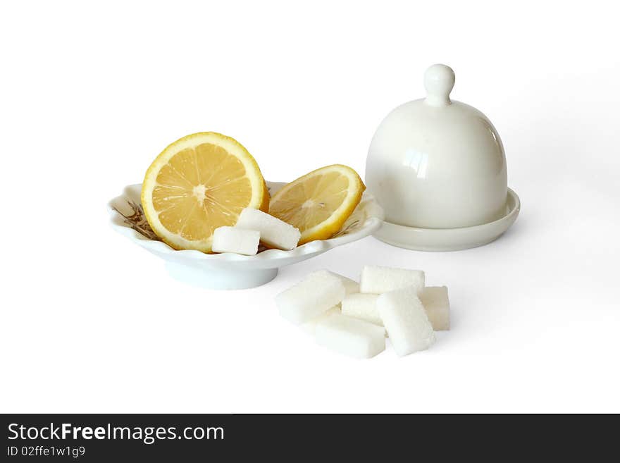 Lemon and sugar on white background