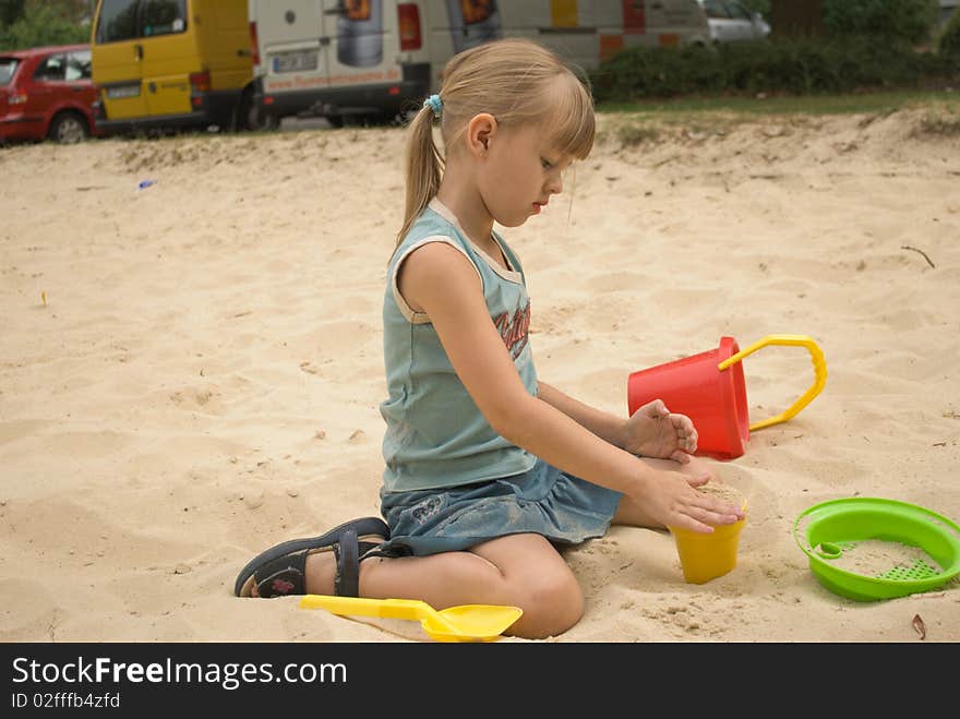 A girl playing in a Sand box. A girl playing in a Sand box