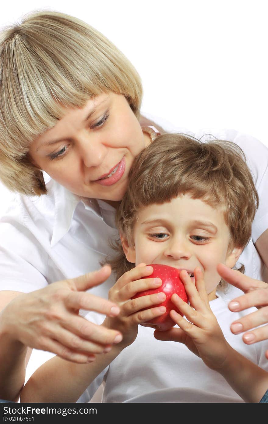 Woman and little boy playing and eating an apple. Woman and little boy playing and eating an apple