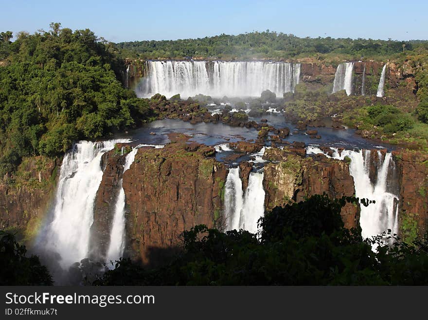 Iguassu waterfalls on a sunny day early in the morning. The biggest waterfalls on earth.