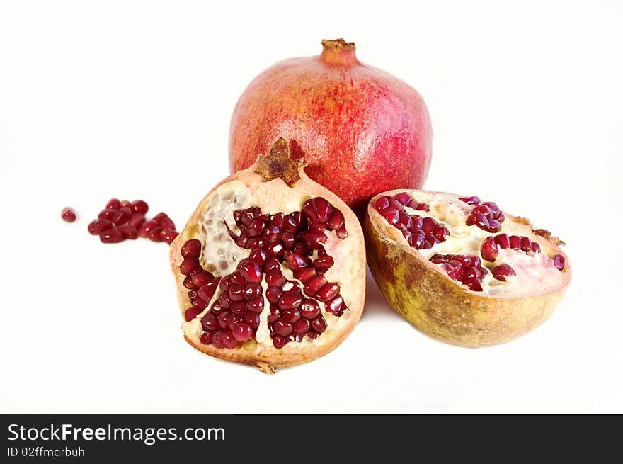 Pomegranate halves on a white background. Pomegranate halves on a white background