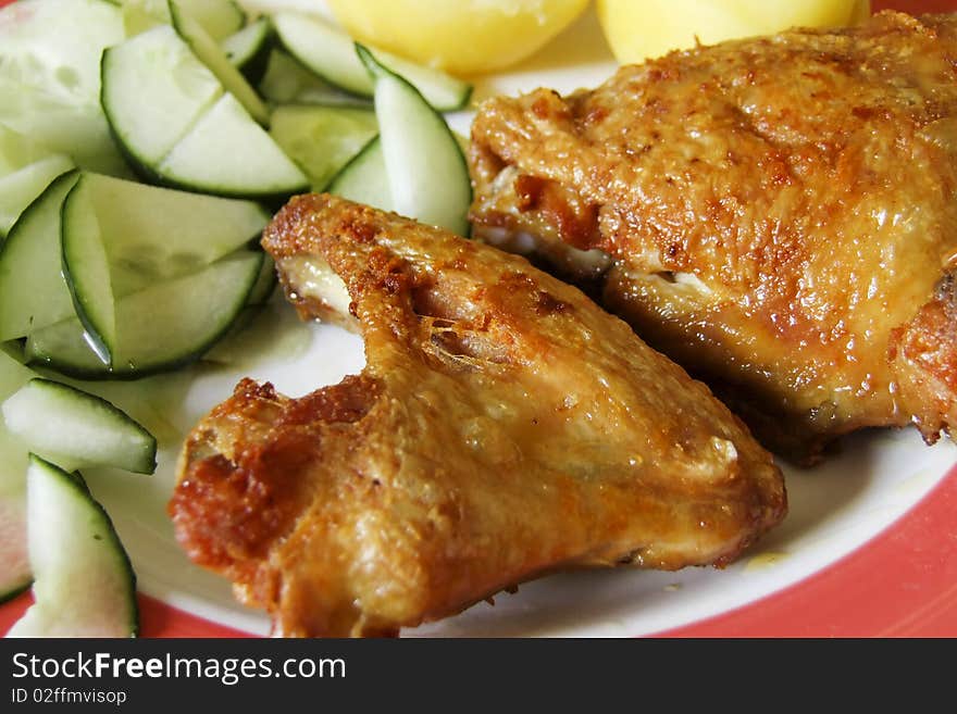 Grilled chicken with cucumber salad on a plate