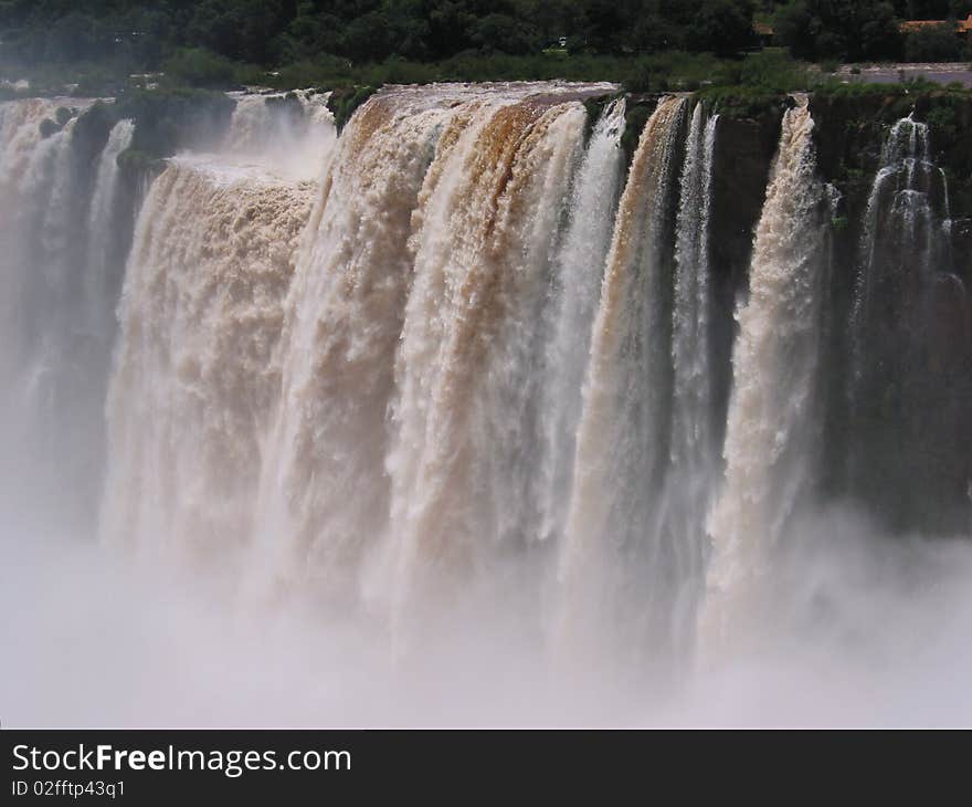 Iguassu waterfalls on a sunny day early in the morning. The biggest waterfalls on earth.