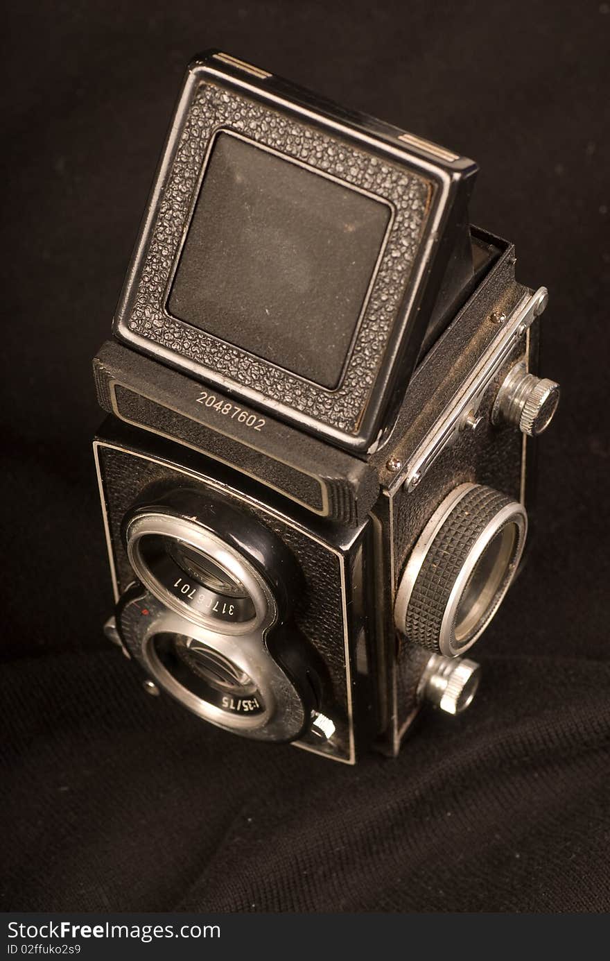 Old camera on black background