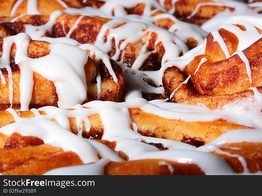 The sweet pie with cinnamon is watered from above by sugar glaze.