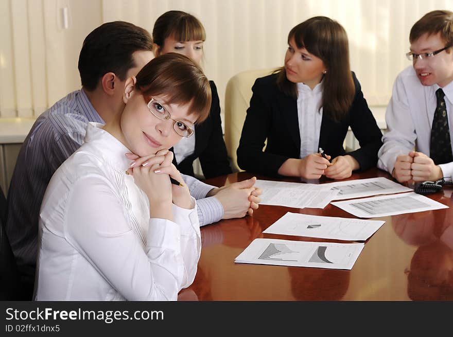 Young charming business woman. Leader of the head of a promising new project - leads his team to success.