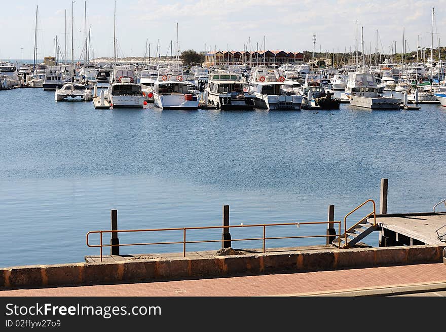 Large number of white yachts in the bay at the pier