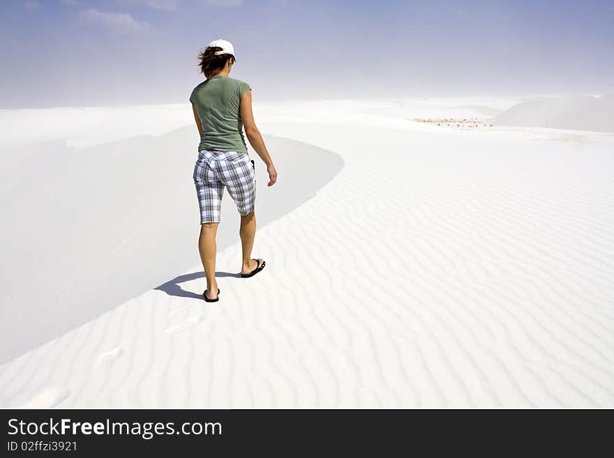 Girl walking white dunes