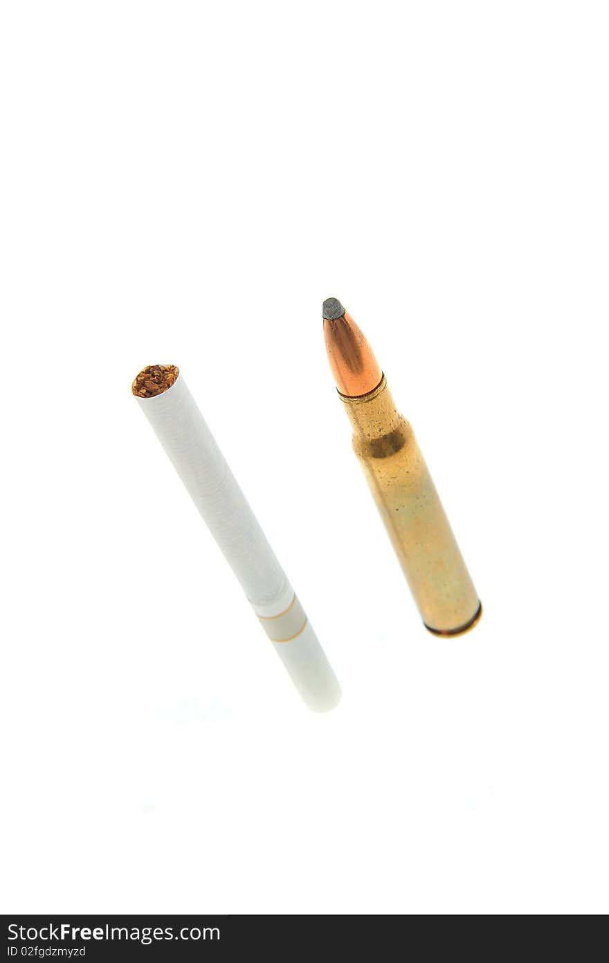 One isolated bullet and one cigarette. One isolated bullet and one cigarette