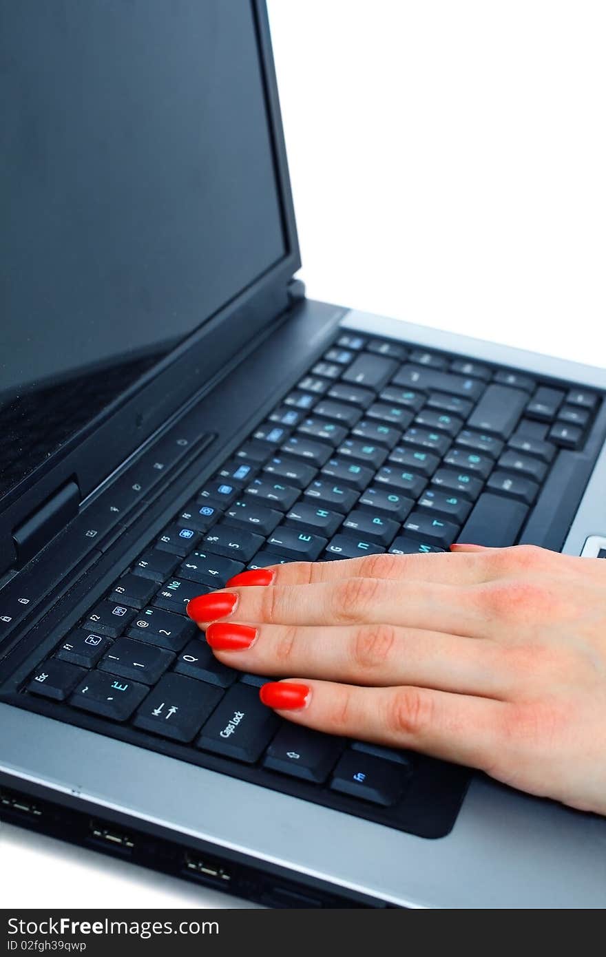 Fingers typing on a modern laptop keyboard