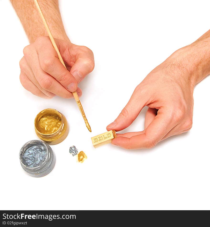 Man makes a gold bar bullion - isolated on white