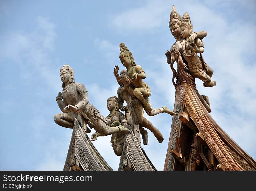 Exquisite hand carved wooden figures atop three flying-eaved roof gables at remarkable Sanctuary of Truth Temple in Pattaya, Thailand. Exquisite hand carved wooden figures atop three flying-eaved roof gables at remarkable Sanctuary of Truth Temple in Pattaya, Thailand.