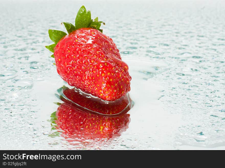 Juicy strawberries in drops of water with reflection. Juicy strawberries in drops of water with reflection