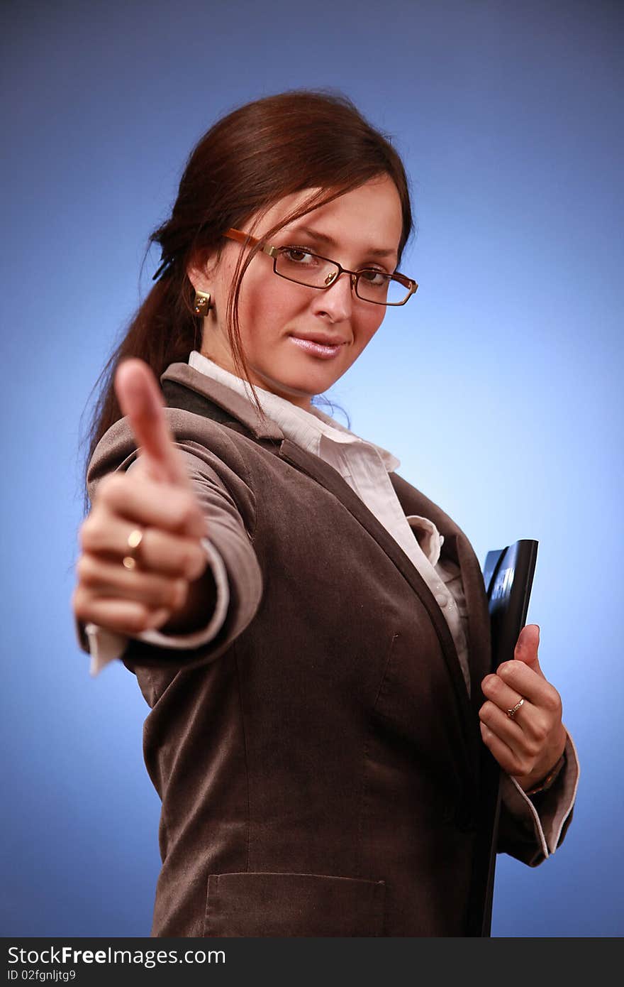 Young businesswoman showing thumb up. Young businesswoman showing thumb up