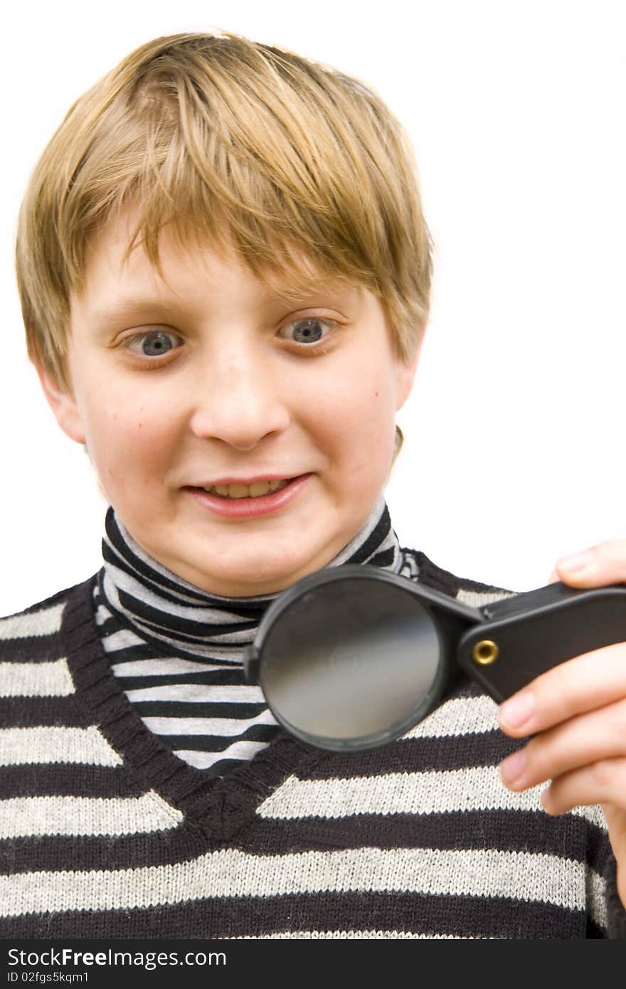 A boy looking through a magnifying glass on a white background. A boy looking through a magnifying glass on a white background