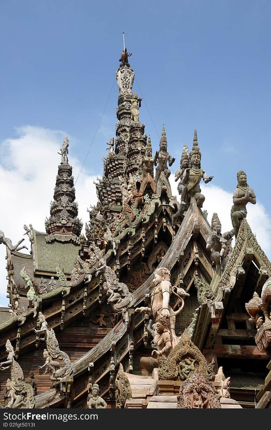 The outstanding landmark Sanctuary of Truth temple begun in 1981 is made entirely of wood with a multitude of exquisite hand-carved figures and statues adorning its gabled roofs, towers, and walls in Pattaya, Thailand. The outstanding landmark Sanctuary of Truth temple begun in 1981 is made entirely of wood with a multitude of exquisite hand-carved figures and statues adorning its gabled roofs, towers, and walls in Pattaya, Thailand.