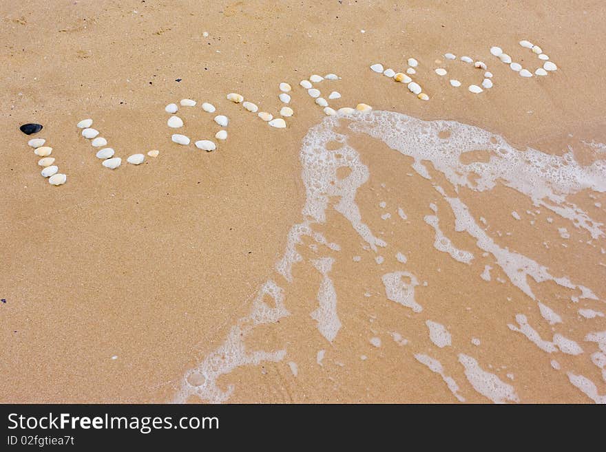 I Love you in sand on a a beach