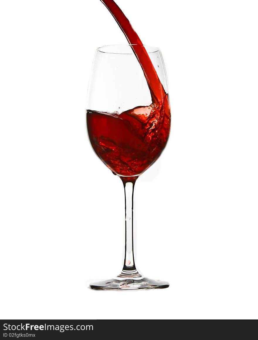 Pouring red wine isolated on white