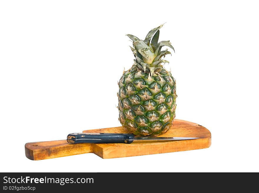 Pineapple, cutting board and knife, isolated on a white background.