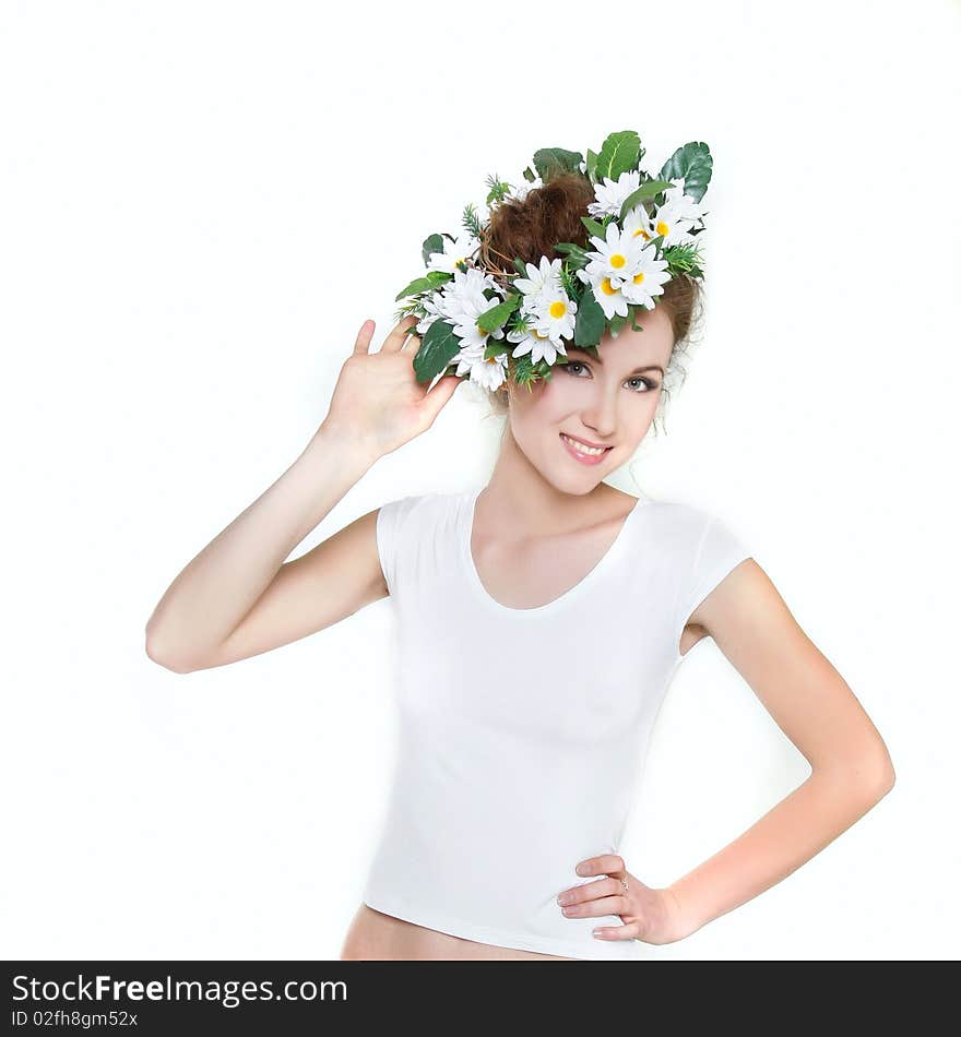 Young beautiful woman in floral wreath over white