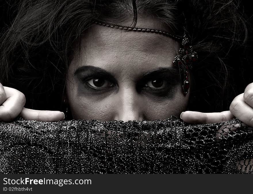 Portrait of a witch with jewelry on a dark background. Portrait of a witch with jewelry on a dark background