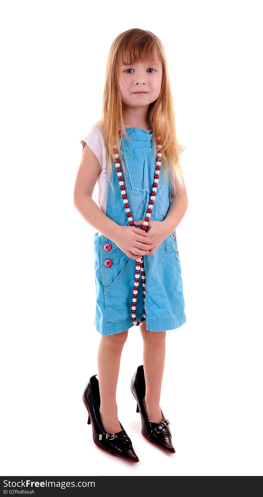 Small blonde girl in mam's high-heeled shoes on white background. Small blonde girl in mam's high-heeled shoes on white background