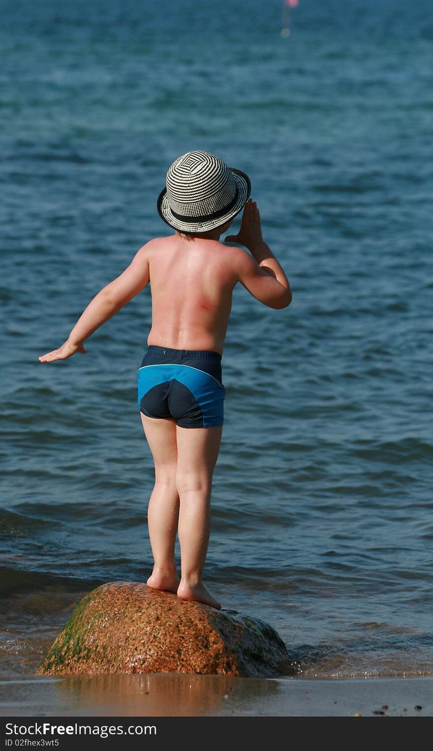 Happy summer child. Kid playing on the beach.