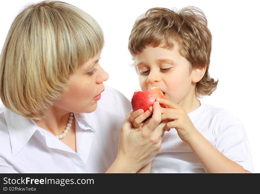 Woman and little boy playing and eating an apple. Woman and little boy playing and eating an apple