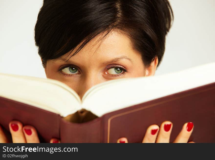 Pensive woman with book