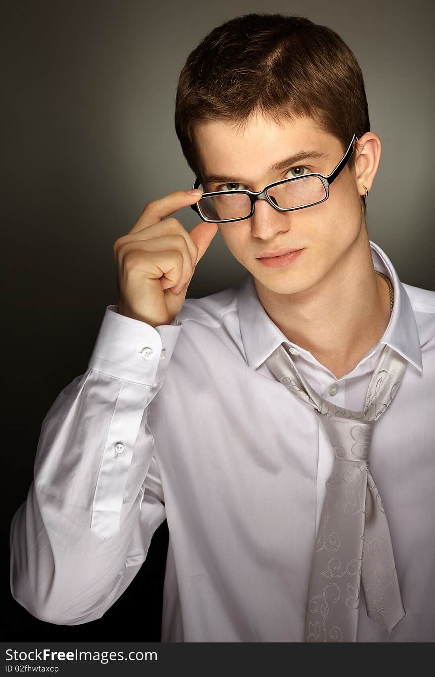 Young handsome caucasian man over grey background. Young handsome caucasian man over grey background