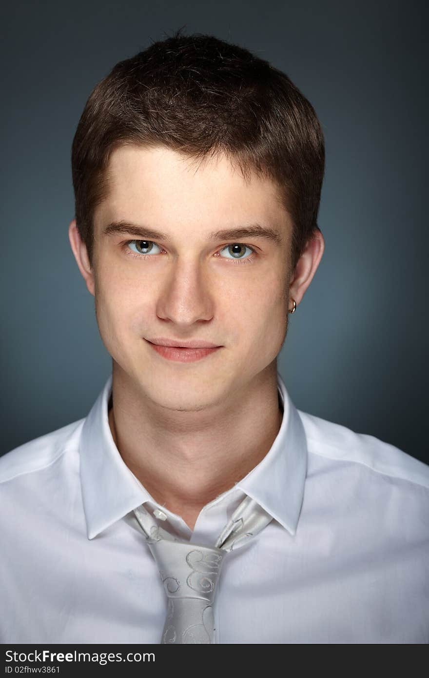 Young handsome caucasian man over grey background. Young handsome caucasian man over grey background