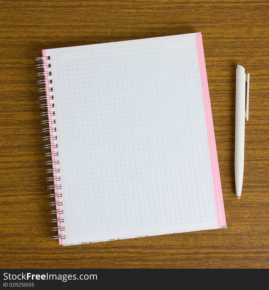 Notebook and pen on a wooden table