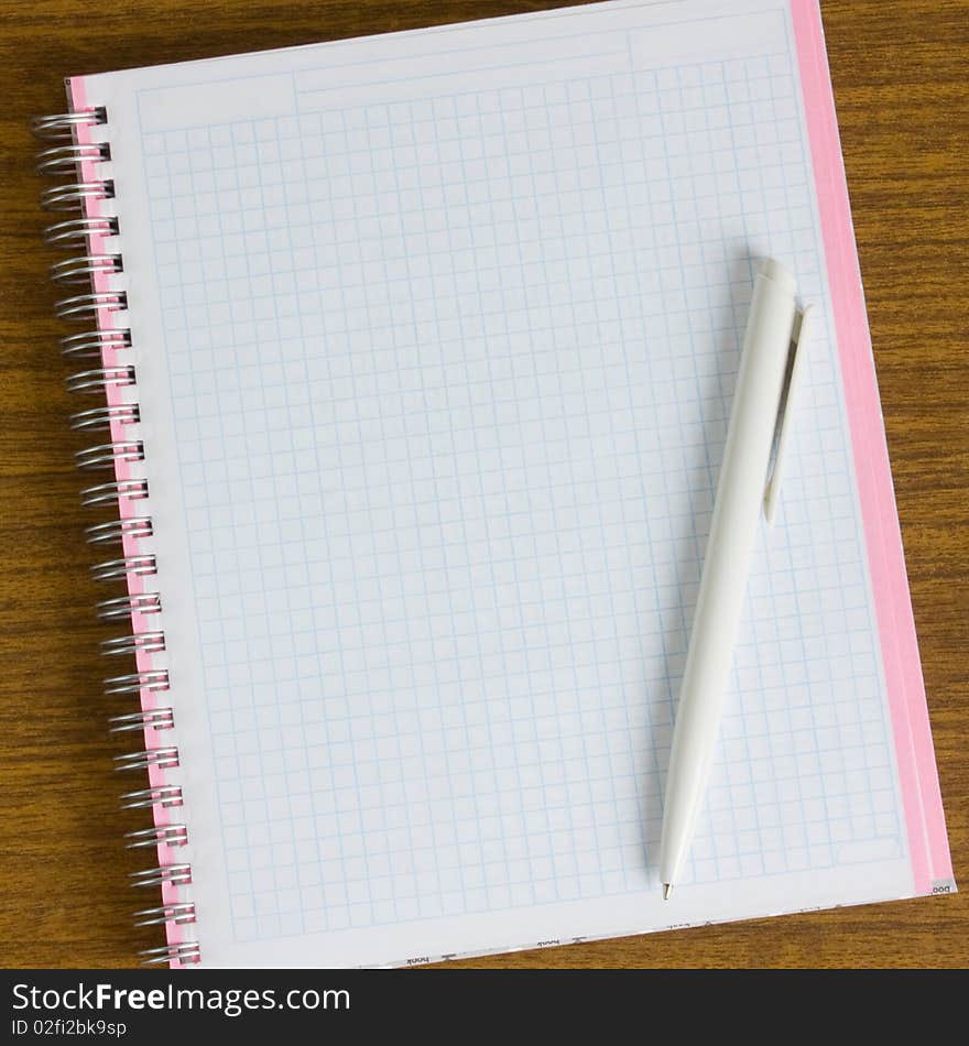 Notebook and pen on a wooden table