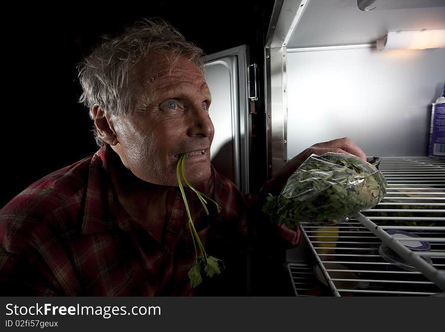 Eccentric Man Staring Into Refrigerator With Green