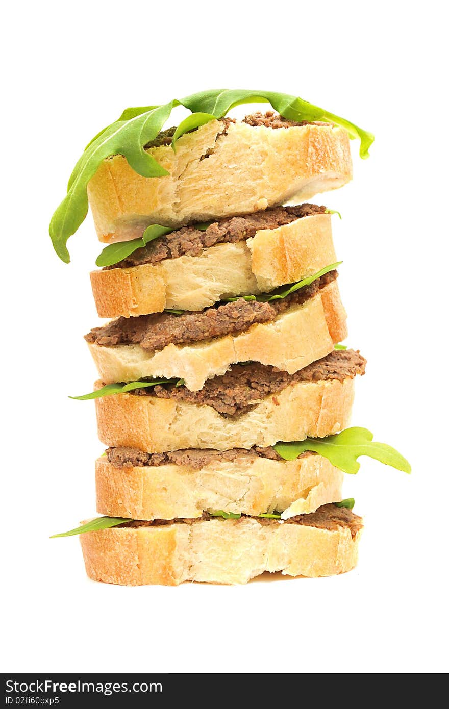 Sandwiches: pate and arugula leaves on baguette. Antipasto. Sandwiches: pate and arugula leaves on baguette. Antipasto