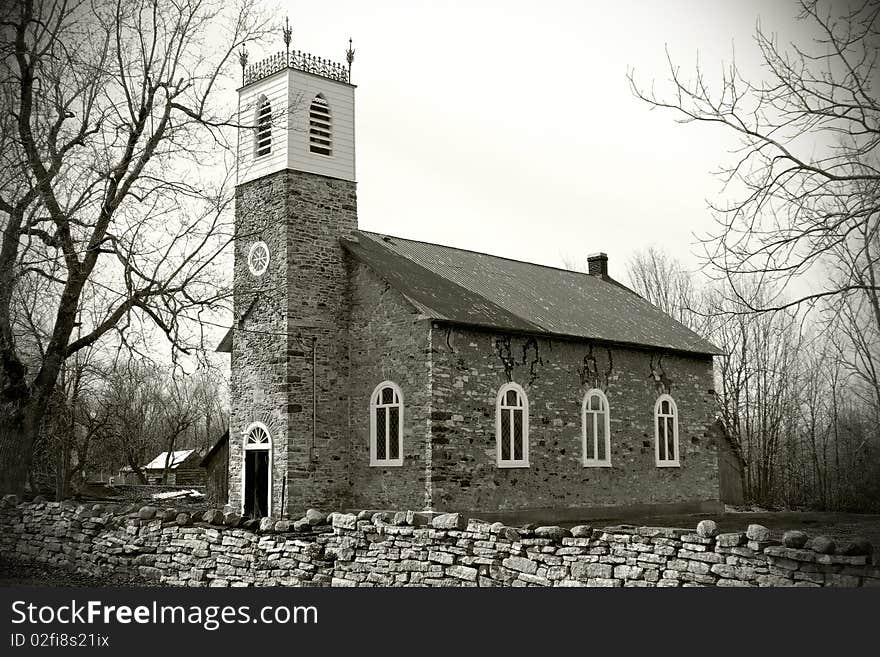 Old style photograph of an old, small, early 19th century, stone church in the country. Old style photograph of an old, small, early 19th century, stone church in the country.